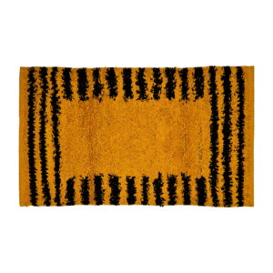 "Modern bathroom with a freestanding white bathtub and a bold yellow and black striped bath mat on a white tiled floor, complemented by floral wallpaper and elegant decor."